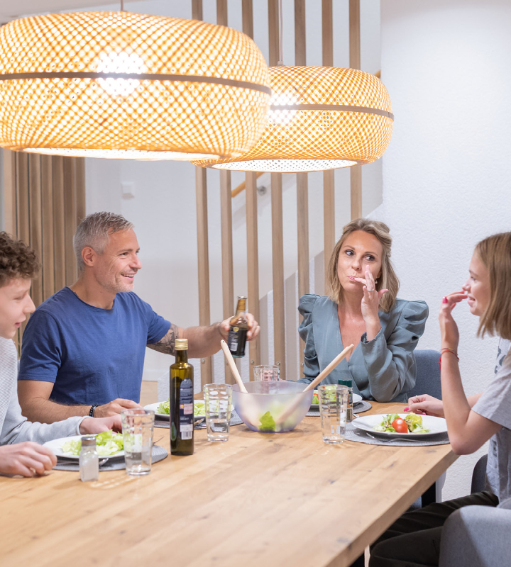 Couple dans un intérieur moderne et confortable, illustrant les avantages du raccordement au chauffage à distance de Groupe E.
